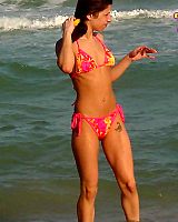 Bruntte Teen In Bikini Toying At Beach