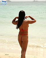 Girl With Big Oiled Tits In Bikini Posing On The Beach
