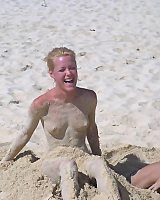 Naked woman laying on the beach